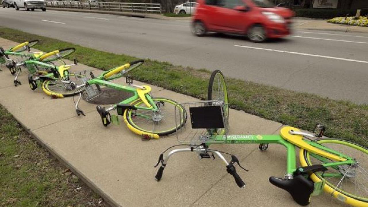 A group of Lime Bikes lying overturned on a side walk along Lemmon Avenue in Dallas, Texas. From D.C. and Dallas to Seattle and San Diego, the dockless apocalypse, or “wheelmageddon,” has dawned. — Fort Worth Star-Telegram/TNS lime bikes on the ground
